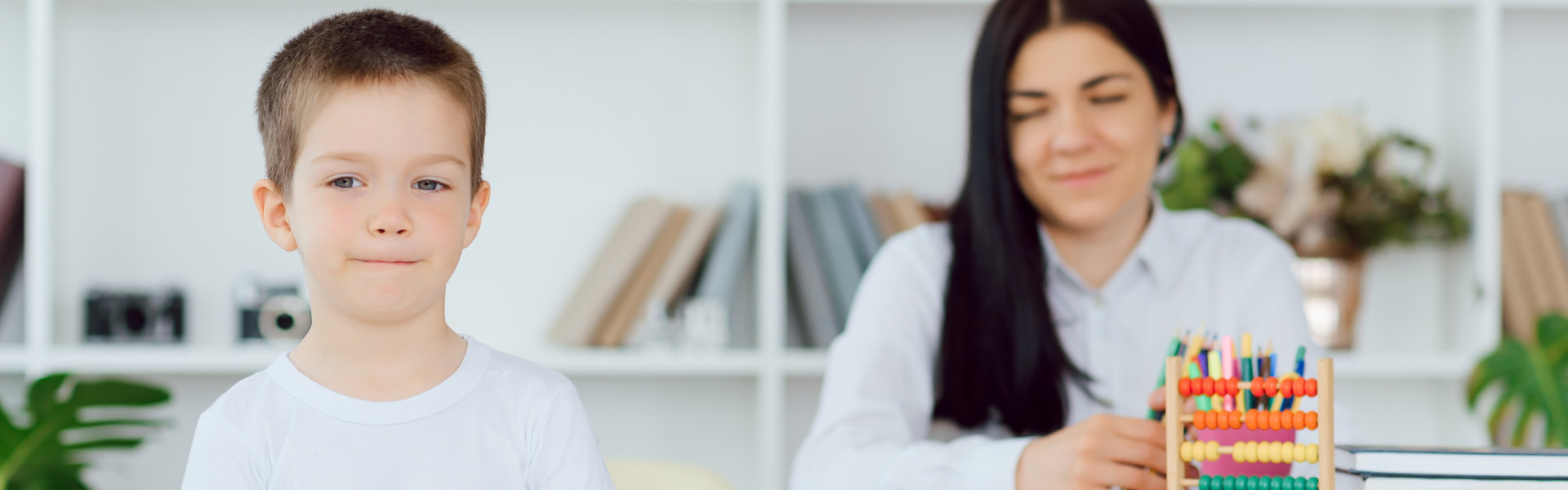 Female private tutor helping young student